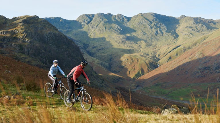 Two people mountain biking in the Lake District, Cumbria